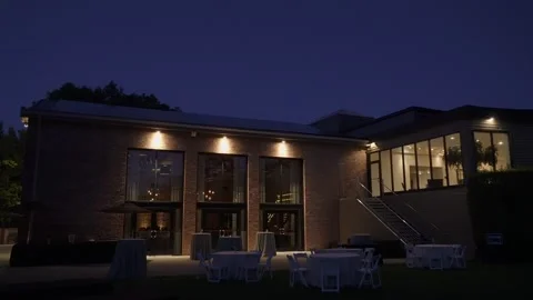 Nighttime Celebration Under Warm Lights, Outdoor Setting With Gentle Lighting Stock Footage 323777352