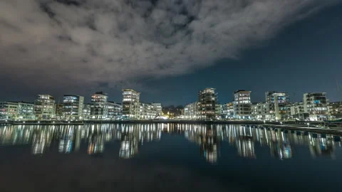 Nighttime Cityscape with Reflections on Water Stock Footage 303646844