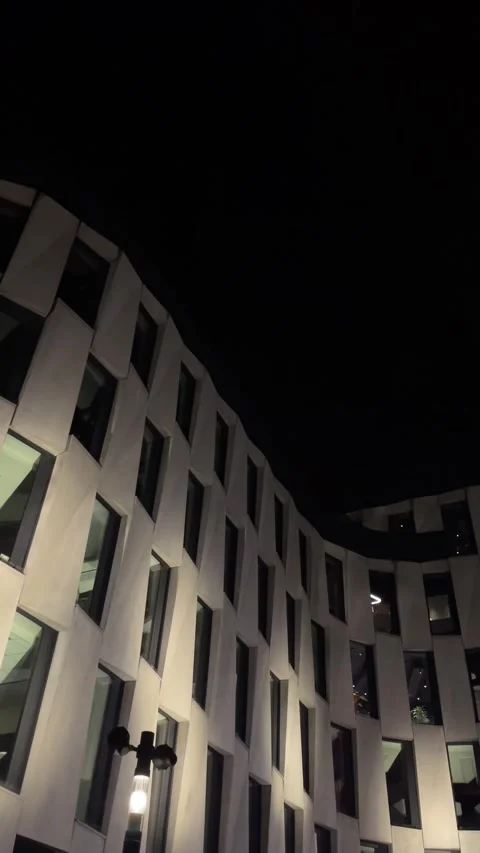 Nighttime cityscape showcasing luminous office windows and contemporary design Stock Footage 335434248