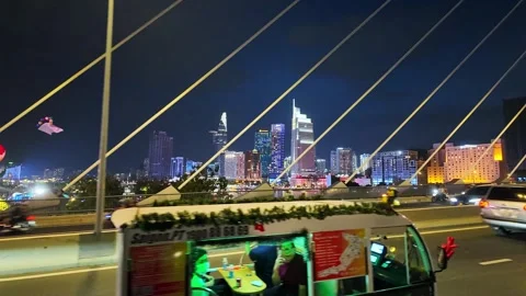 Nighttime cityscape through cable-stayed bridge shows Saigon Stock Footage 295327986