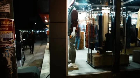 Nighttime Clothing Store Window Display, A nighttime street view of a cloth.. Stock Footage 304911490