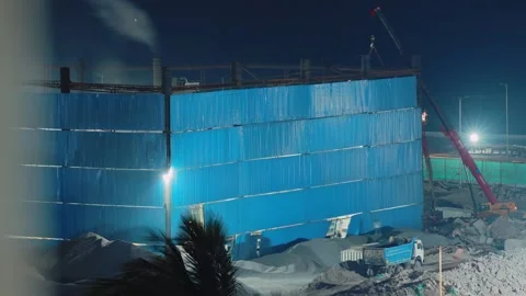 Nighttime construction site time lapse with Sany crane and dump truck by the Stockbeeldmateriaal 341374694