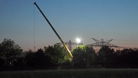 Nighttime construction work on power lines. A power pole is being dismantled Stock Footage 341870978