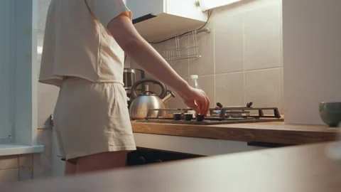 Nighttime cooking activity. Evening culinary moment in small living space Stock Footage 345536527