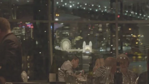 Nighttime Dining Scene Overlooking Sydney City Lights and Amusement Park Stock Footage 345726480