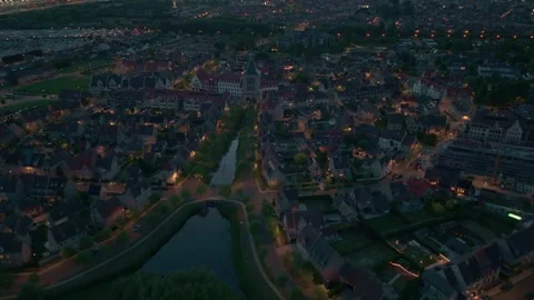 Nighttime Drone Flight Over Heulebrug with Streetlights and Water | FlyLens 4K Stockbeeldmateriaal 309049765