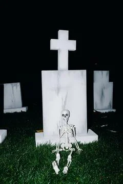 Nighttime Graveyard Scene with Skeleton Stock Photos
