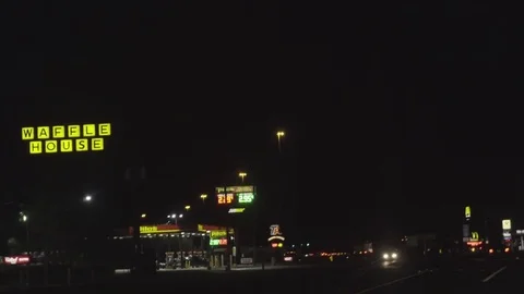 Nighttime Highway Gas Station Drive By Stock Footage