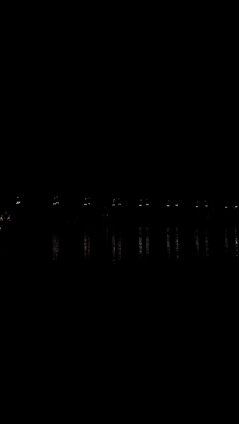 Nighttime lights on a bridge over a river vertical. A road bridge at night. Stock Footage 346322407