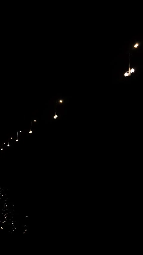 Nighttime lights on a bridge over a river vertical. A road bridge at night. Stock Footage 346322418