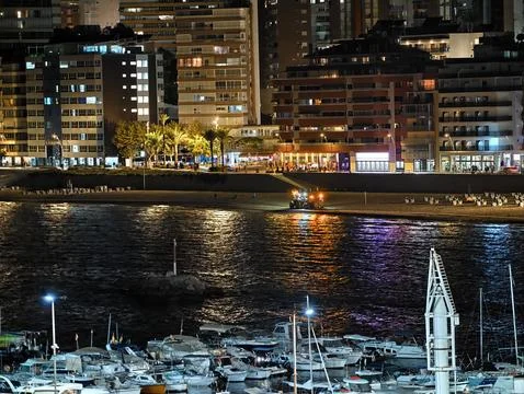 Nighttime marine backdrop setting, peaceful waterfront with illuminated Stock Photos