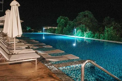 Nighttime pool glows with blue lights Stock Photos