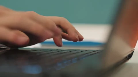 Nighttime programmer focuses intensely on keyboard. Focused student developer Stock Footage 346226595