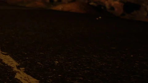 Nighttime scene showing a road with some distant objects at the side Stock Footage 340608730
