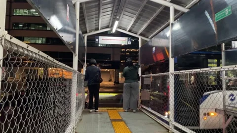 Nighttime scene at a temporary bus stop in an urban city. Stock Footage 333809596