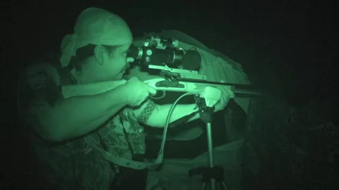 Nighttime shooting practice session with a rifle in dark conditions Stock Footage 327958633
