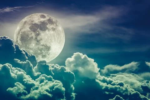 Nighttime sky with clouds and bright full moon with shiny.  Cross process Stock-Fotos