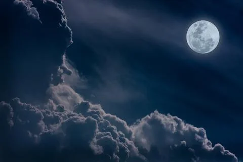 Nighttime sky with clouds, bright full moon would make a great background. Stock Photos