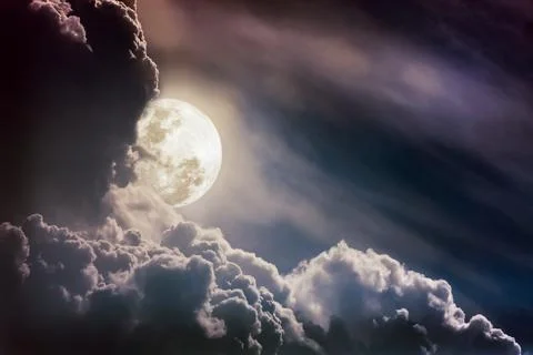 Nighttime sky with clouds, bright full moon would make a great background. Stock Photos