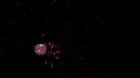 Nighttime sky dances with fiery orbs, radiant spiral fire illuminates vast dark Stock Footage 346512591