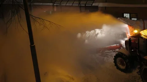 Nighttime snow removal operation clearing roads driveways during winter storm Stock Footage 331506125