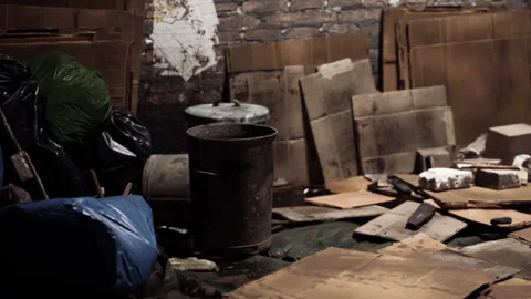 Nighttime storage space cluttered with discarded boxes and items 動画素材 308879625