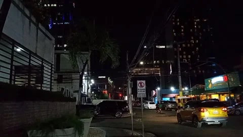 Nighttime Street Scene with Traffic, City Lights, and Commercial Buildings Video stock 347083553