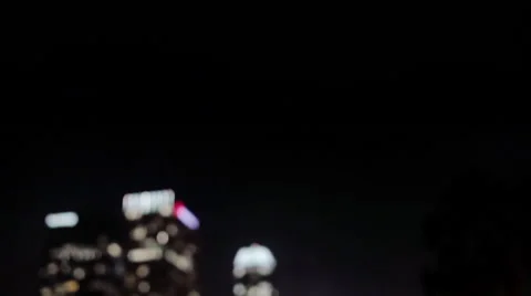 Nighttime tight tilting down shot of the Downtown Los Angeles skyline, with rack Vídeo Stock 62340642