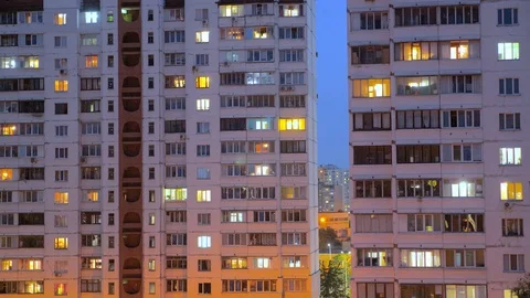 Nighttime time lapse of illuminated building windows at night with people living Stock Footage 112228057