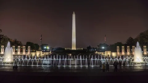Nighttime time-lapse of tourists at world war 2 memorial and Washington Monument Stock Footage 82831339