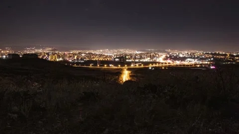 Nighttime Timelapse of a Distant City Viewed from a Hilltop 스톡 동영상 239440383