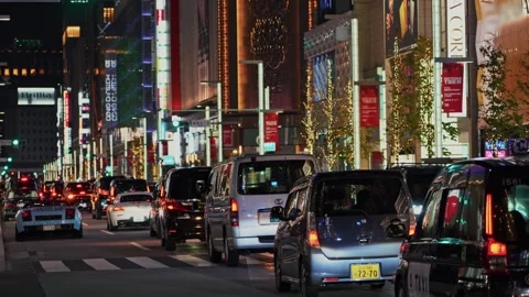 Nighttime Traffic Flow Through Luxury Shopping District in Tokyo Japan Видео 339201504