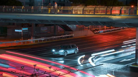 Nighttime Traffic Jam Under Elevated Roadway with Bright Headlights 動画素材 336225381