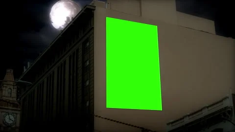 Nighttime Urban Billboard Green Screen Mockup on Building Facade Under Full Moon Stockbeeldmateriaal 341500259