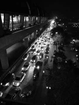Nighttime Urban Traffic Under Elevated Train Tracks Stock Photos