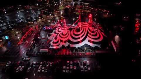 Nighttime video of a black-and-white horror-themed circus tent with red lights Stock Footage 345802892