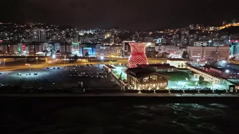 Nighttime view of a city with a large clock tower in the middle of the city Stock Footage 268902132