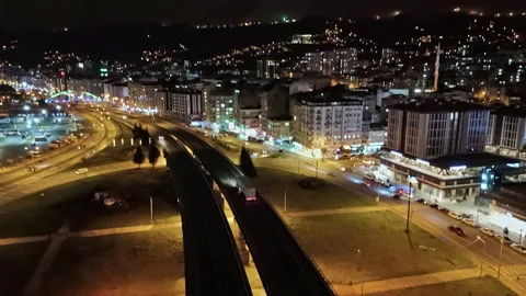 Nighttime view of a city with a train on the tracks Stock Footage 268907619