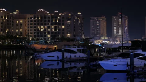 Nighttime view of marina in Doha, showcasing beautiful boats and captivating Stock Footage 303378381