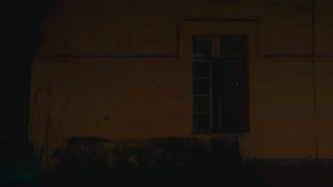 Nighttime View of Old Building Window and Exterior Wall in Dim Light Stock Footage 344488018