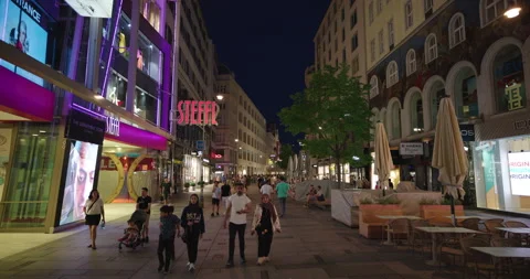 Nighttime view of people walking on Karntner Strasse in Vienna, Austria Stock Footage 252016161