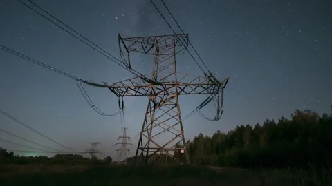 Nighttime view of power lines against a starry sky in a remote area with clear Stock Footage 286313622