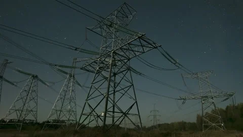 Nighttime view of power lines against a starry sky in a remote area with clear Stock Footage 286416992