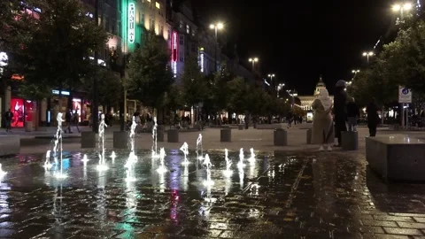 Nighttime View of Wenceslas Square with Moving Fountains and Pedestrians Stock Footage 288042802