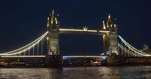 Nighttime Waterside View Looking Towards Brightly Lit Tower Bridge London Stock Footage 203761369