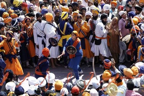 Nihang Sikh devotees perform martial skill in crowd on occasion of Hola Mo... Stock Photos