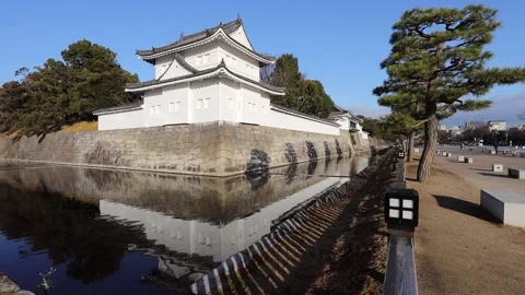 Nijo white corner tower over moat in historic Kyoto city of Japan as 4k pan. Stock Footage 144176087