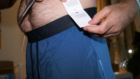 Nike Tech Pack Men's Running Shorts measuring by man Stock Footage 111536320