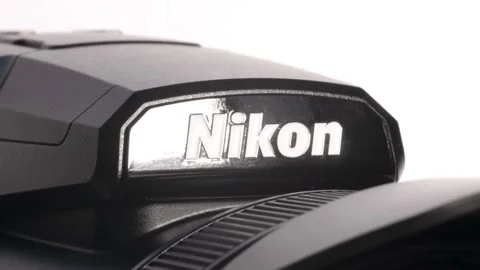A Nikon logo camera rotating on a white background. Stock Footage 231919056