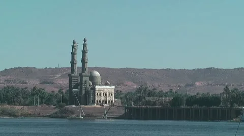 Nile river with mosque in background near Aswan Видео 7734788
